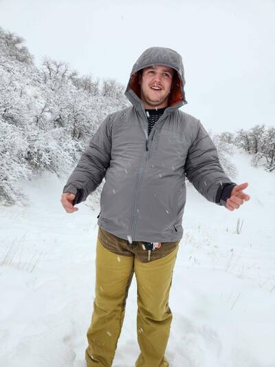 Man in Orvis Pro Insulated Hoodie in snow with hands out